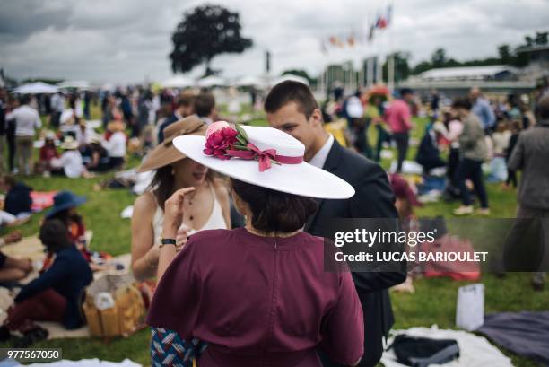 Woman wearing a hat attends the 169th Prix de Diane horse racing on June 17, 2018 in Chantilly, northern Paris.