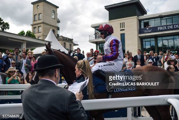 British jockey PJ Mcdonald on Laurens takes part in the presentation round of the 169th Prix de Diane horse racing on June 17, 2018 in Chantilly,...