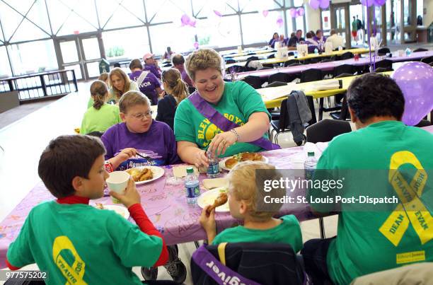 Evan Pina-White from Eureka and his mother Mary White sit with the rest of their family during the Rockwood School District's American Cancer Society...