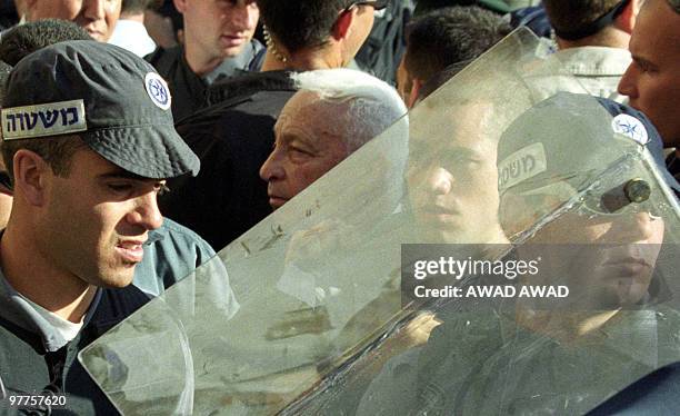 - File pictured dated 28 September 2000 shows right-wing opposition leader Ariel Sharon , flanked by security guards, as he leaves the Al-Aqsa mosque...