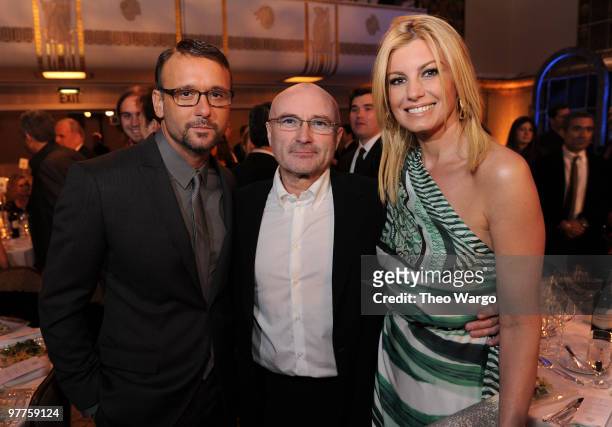 Exclusive* Tim McGraw and Faith Hill pose with inductee Phill Collins at the 25th Annual Rock and Roll Hall of Fame Induction Ceremony dinner at The...