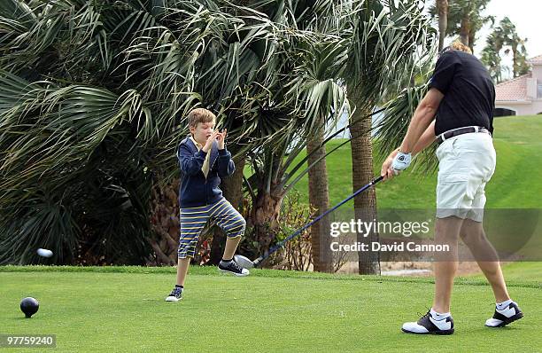 Ernie Els of South Africa with his young son Ben during the Els for Autism Pro-Am on the Champions Course at the PGA National Golf Club on March 15,...