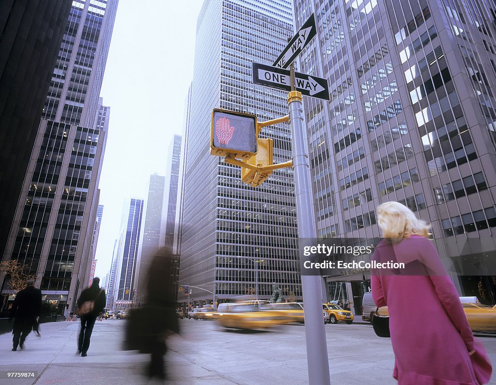 People waiting for a yellow cab in New York.