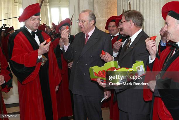 King Albert II of Belgium and members of the strawberry producers association try the first strawberries of the year at Laeken Castle on March 16,...