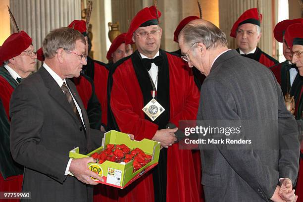 King Albert II of Belgium inspects the first strawberries of the year offered by members of the strawberry producers association at Laeken Castle on...