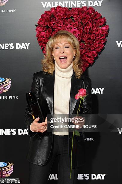 Actress Barbara Eden holds a flower as she arrives at the Los Angeles Premiere for the "Valentine's Day" film at the Grauman's Chinese Theatre in...