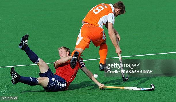English hockey player Barry Middleton and the Netherlands' Rob Reckers vie for the ball during their World Cup 2010 classification match for the 3rd...