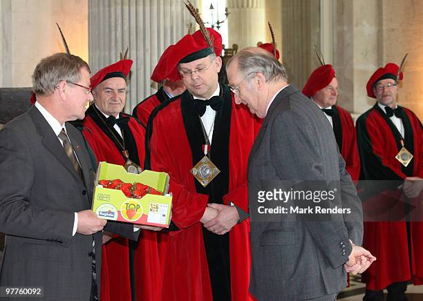 King Albert II of Belgium inspects the first strawberries of the year offered by members of the strawberry producers association at Laeken Castle on...