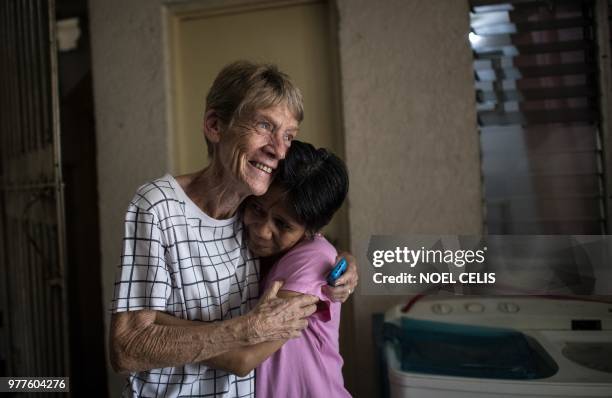 Australian nun Patricia Fox hugs sister Beth Purgo inside her house in Manila on June 18, 2018. - An Australian nun ordered to leave the Philippines...