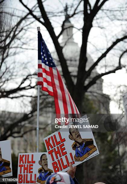 Participants display placards during a demonstration organized by the American Grass Roots Coalition and the Tea Party Express in Washington, DC, on...