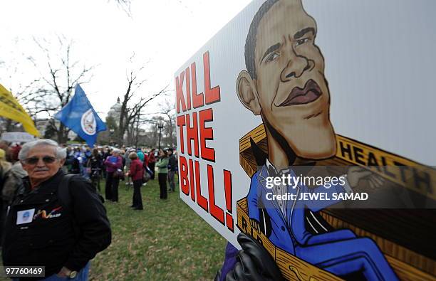 Participants display placards during a demonstration organized by the American Grass Roots Coalition and the Tea Party Express in Washington, DC, on...