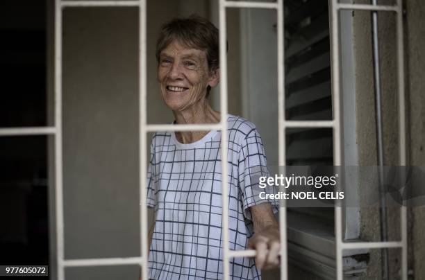 Australian nun Patricia Fox smiles inside her house in Manila on June 18, 2018. - An Australian nun ordered to leave the Philippines after angering...
