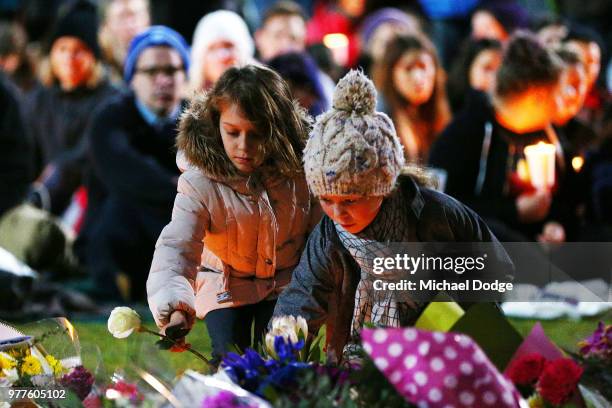 Mourners pay their respects during a vigil held in memory of murdered Melbourne comedian, 22-year-old Eurydice Dixon, at Princess Park on June 18,...