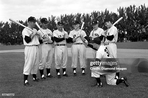 Outfielders Archie Wilson, Bob Cerv, Gene Woodling, Mickey Mantle, Jackie Jensen, Hank Bauer listen to manager Casey Stengel during Spring Training...