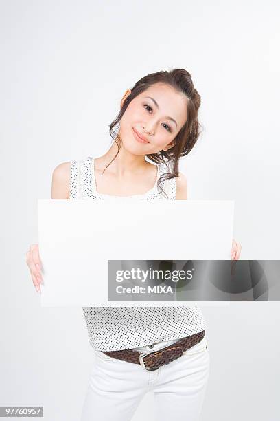 portrait of young woman - ボード　持つ　女性 ストックフォトと画像