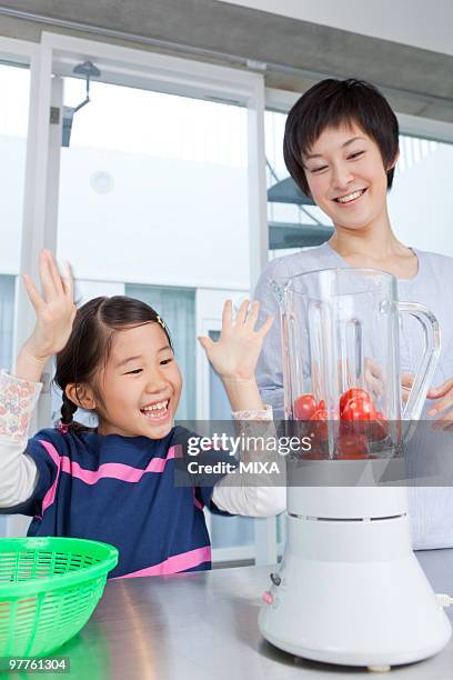 mother and daughter making tomato juice - arm made of vegetables stock pictures, royalty-free photos & images