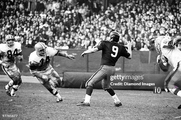 Quarterback Sonny Jurgensen of the Washington Redskins throws a pass while under pressure from Paul Wiggin, Dick Modzelewski and Bill Glass of the...