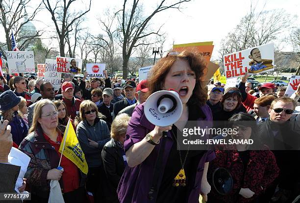 Participants display placards during a demonstration organized by the American Grass Roots Coalition and the Tea Party Express in Washington, DC, on...