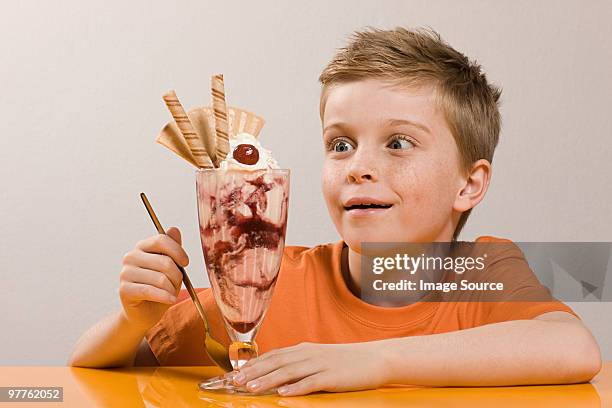 boy looking at ice cream sundae - ice cream sundae stock pictures, royalty-free photos & images