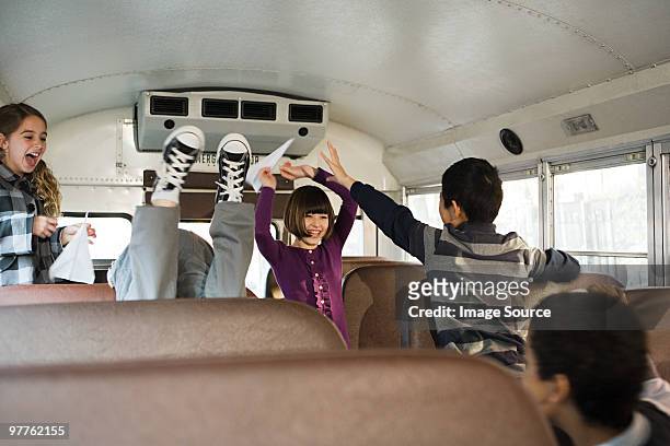 children having fun on school bus - tween heels stock pictures, royalty-free photos & images