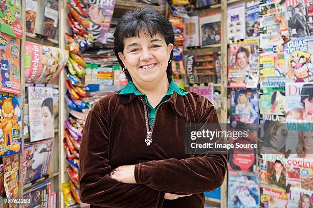 woman working at newsstand - newsstand foto e immagini stock