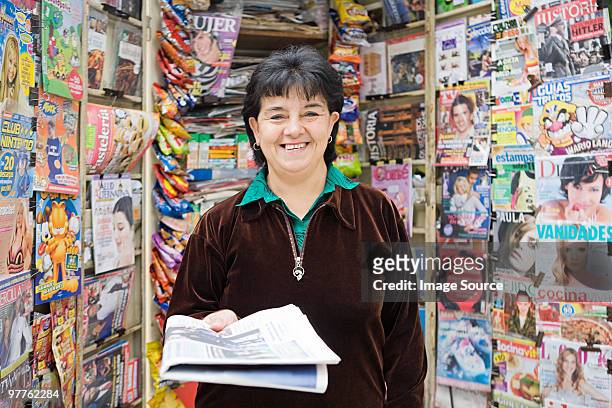 woman working at newsstand - newsstand foto e immagini stock