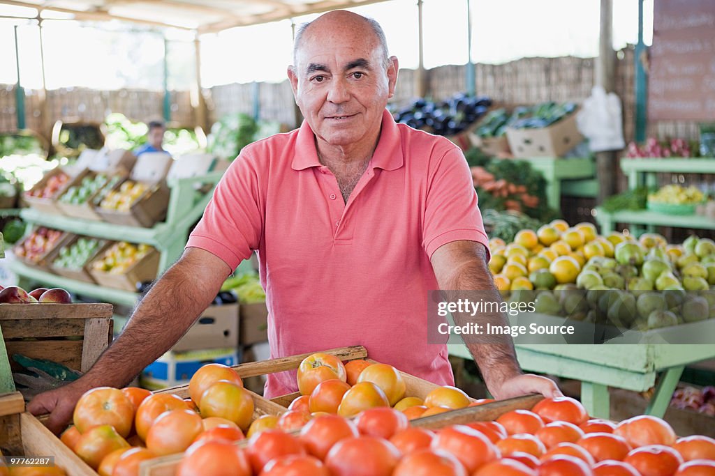 Market trader with tomatoes