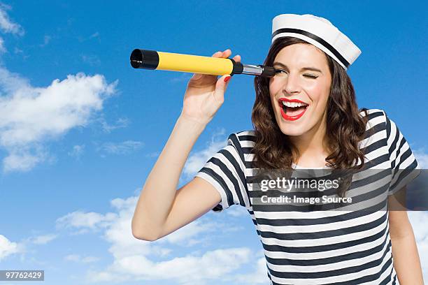 young woman with telescope - zeemansstrepen stockfoto's en -beelden