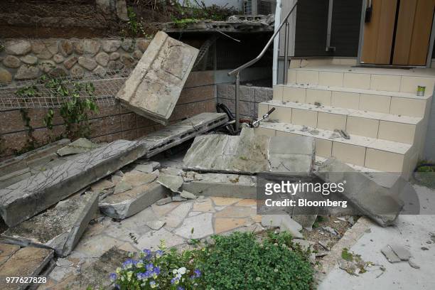 Collapsed walls sit in front of a house after a magnitude 6.1 earthquake in Takatsuki, Osaka, Japan, on Monday, June 18, 2018. Three people were...