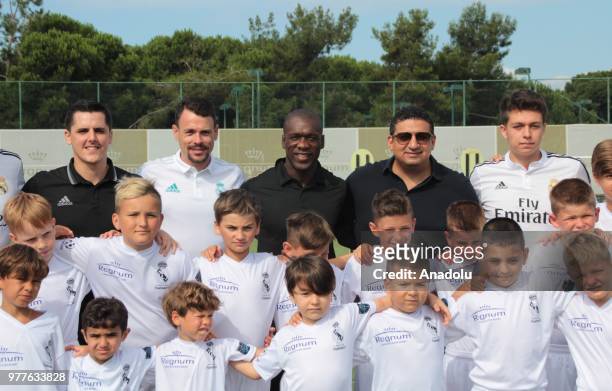Former Dutch midfielder Clarence Seedorf poses for a photo with children at a football field ahead of the opening of a football academy 'Real Madrid...