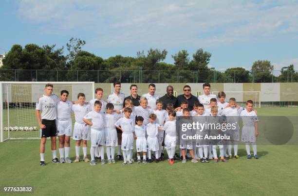 Former Dutch midfielder Clarence Seedorf poses for a photo with children at a football field ahead of the opening of a football academy 'Real Madrid...