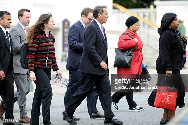 House Minority Leader Rep. John Boehner crosses the street with pedestians as he arrives for a news conference to unveil a new GOP television ad...