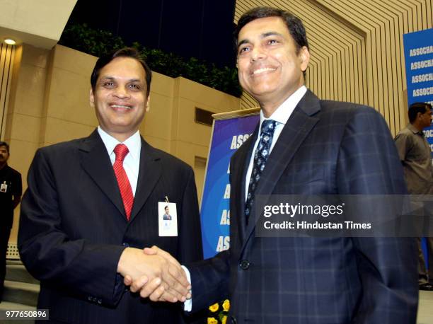 Assocham President - Elect Sajjan Jindal shaking hands with the Assocham President, Venugopal N Dhoot, during the 87th annual session of Assocham on...