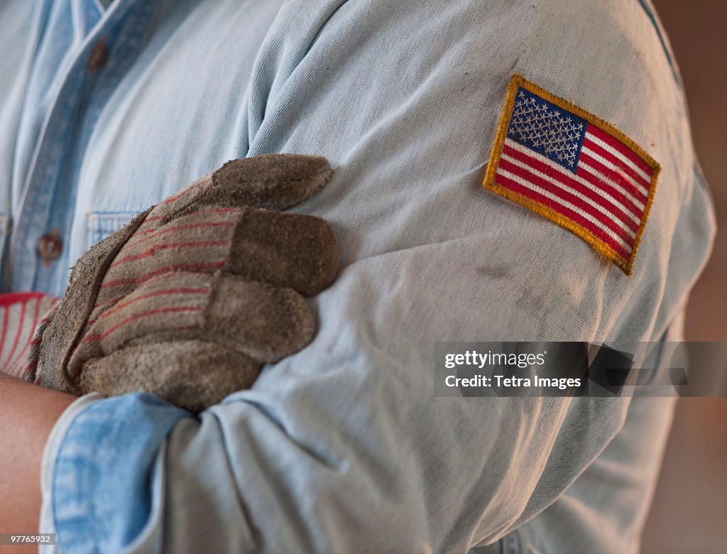 Blue collar working wearing American flag patch