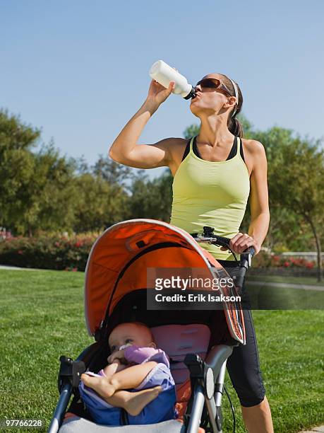 jogger drinking water - three wheeled pushchair stock pictures, royalty-free photos & images