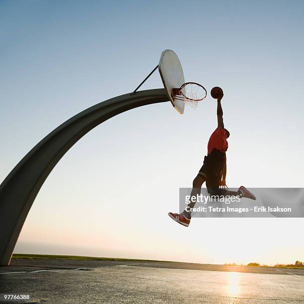 basketball player - basketball dunk stock pictures, royalty-free photos & images