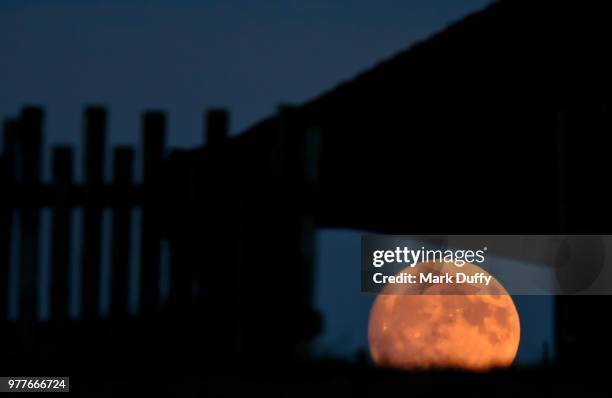 full moon seen through old building window - moon window stock pictures, royalty-free photos & images