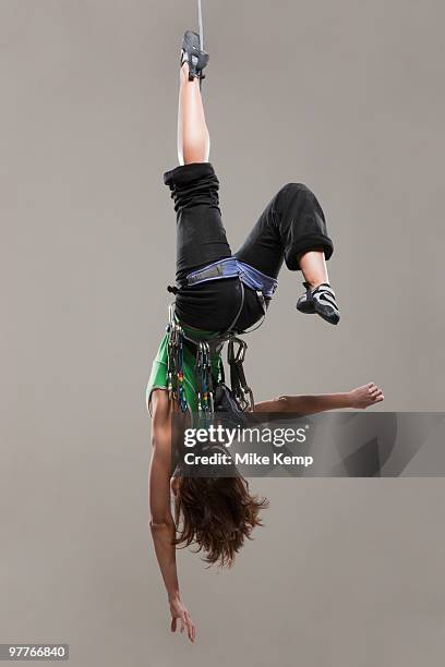 female climber hanging upside down - upside down stock pictures, royalty-free photos & images