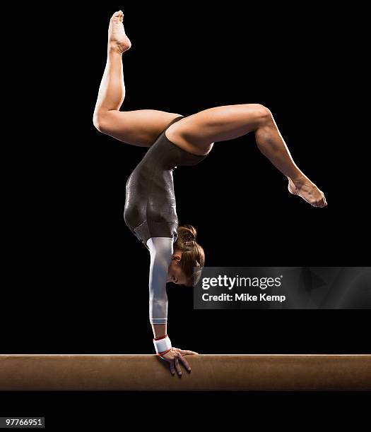 gymnast on balance beam - gymnast stock pictures, royalty-free photos & images