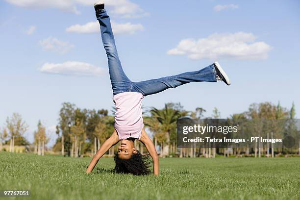 girl doing handstand - cartwheel stock pictures, royalty-free photos & images