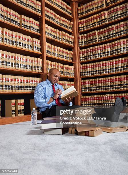 man reading in law library - law library stock pictures, royalty-free photos & images