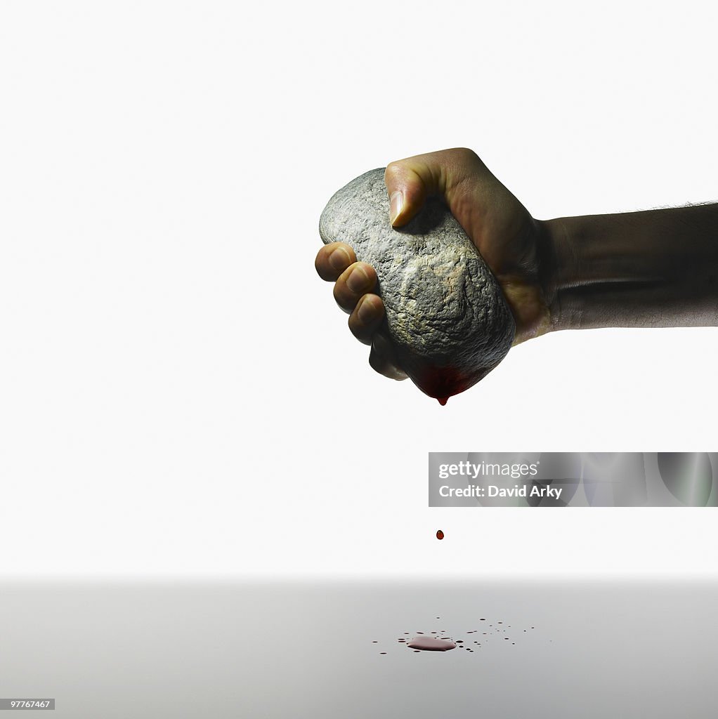 Hand holding a stone