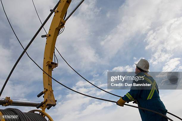 man working with drilling equipment - frac stock pictures, royalty-free photos & images