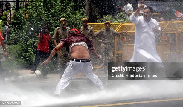 Water cannons are being used on BJP workers who were demonstrating against the steep rise in the prices of petroleum products, at Jantar Mantar on...