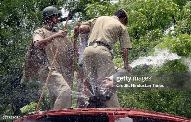 Water cannons are being used on BJP workers who were demonstrating against the steep rise in the prices of petroleum products, at Jantar Mantar on...