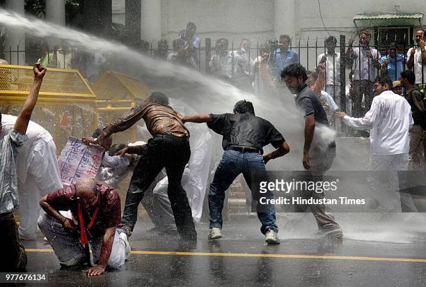 Water cannons are being used on BJP workers who were demonstrating against the steep rise in the prices of petroleum products, at Jantar Mantar on...