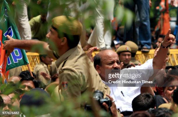 Delhi Pradesh BJP President Harsh Vardhan tries to evade the barricades as Police try to stop BJP workers during their demonstration against the...