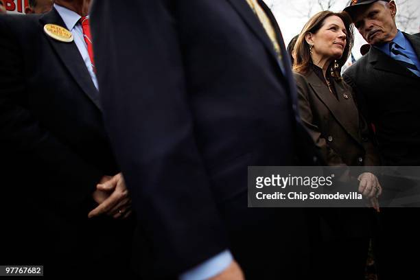 Rep. Michele Bachmann listens to Jim Martin, president of the 60 Plus Association, during a "CODE RED" rally in opposition to the health care reform...