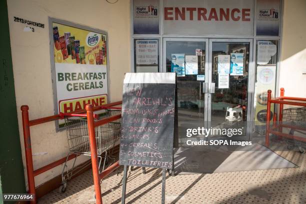 Store in the Gambian capital Banjul advertises goods recently arrived from the UK and France. The nation of Gambia is situated in west africa. In...