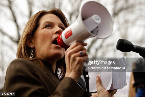 Rep. Michele Bachmann addresses several hundred people with a bullhorn while holding a stack of petitions during a "CODE RED" rally in opposition to...